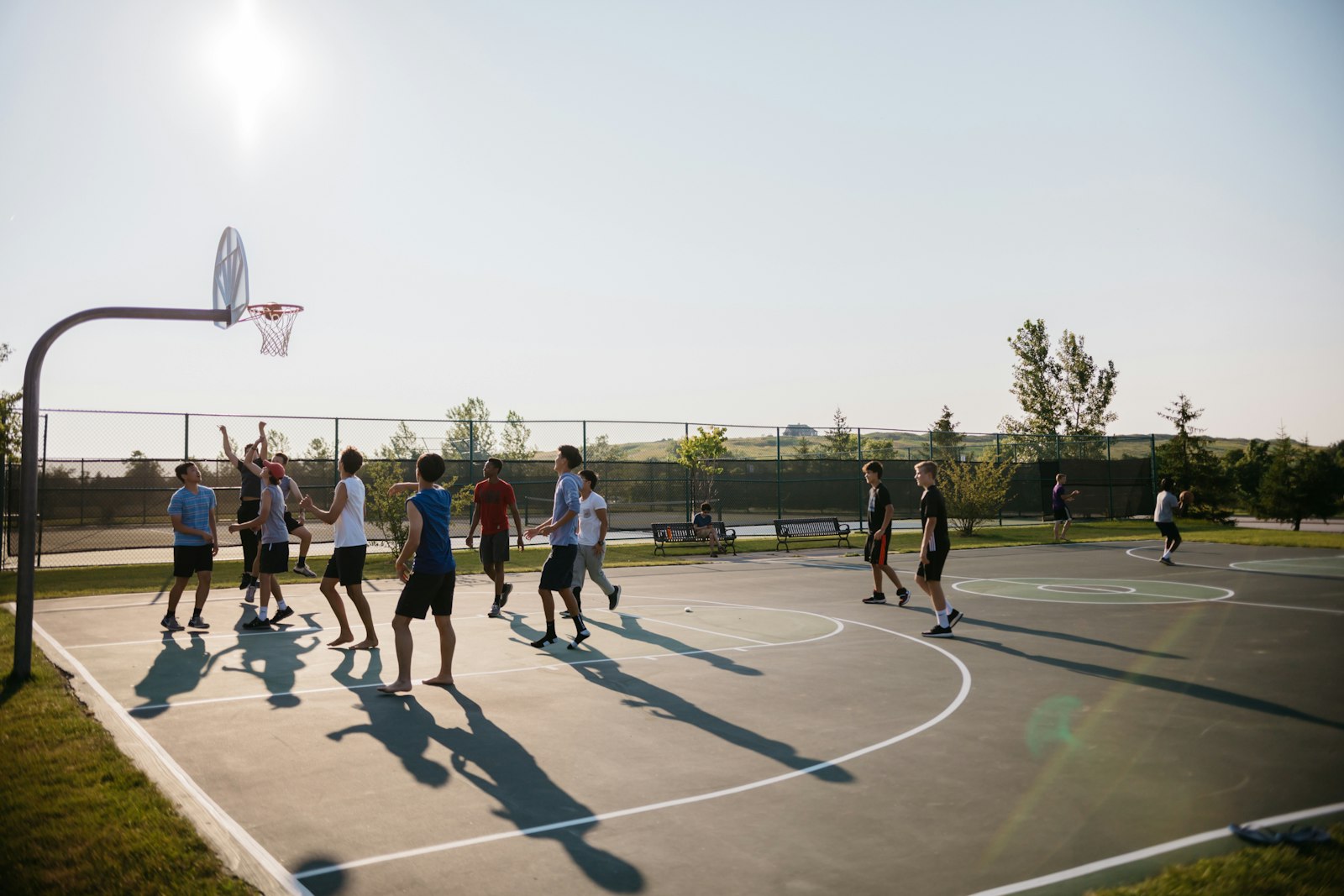 People playing basketball together on an outdoor community court